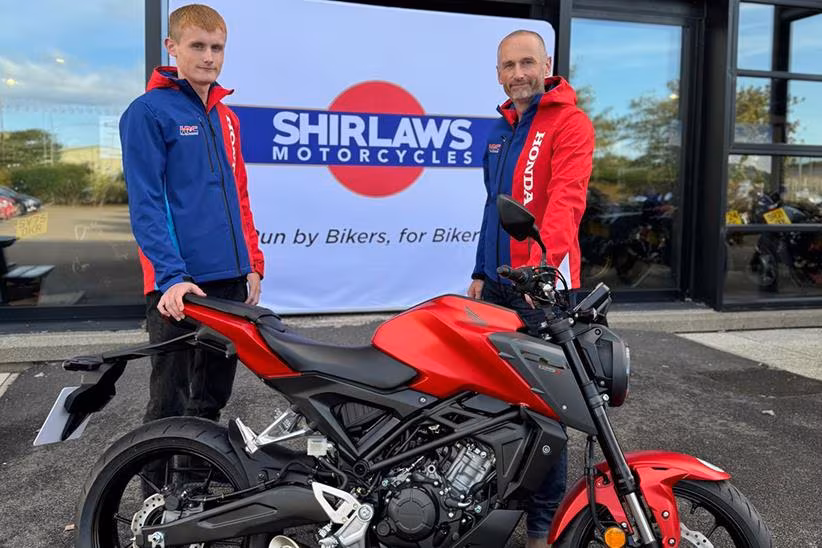 Oli and Joe Purkis stood with the Honda CB125R