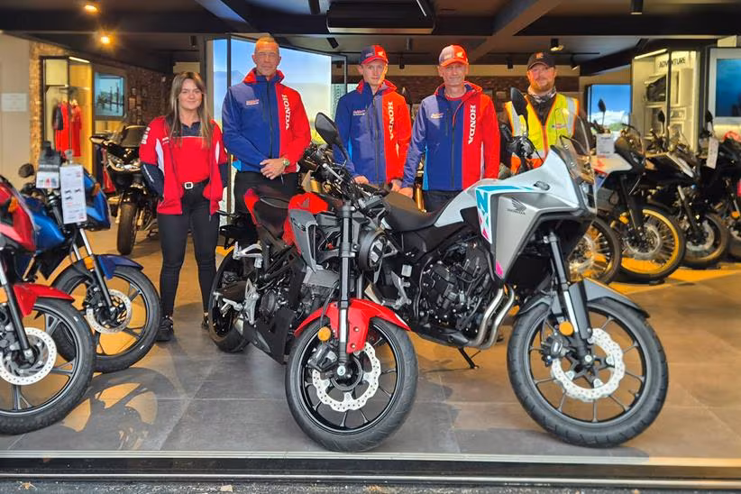 Oli and Joe Purkis stood with the Shirlaws Motorcycles dealership team