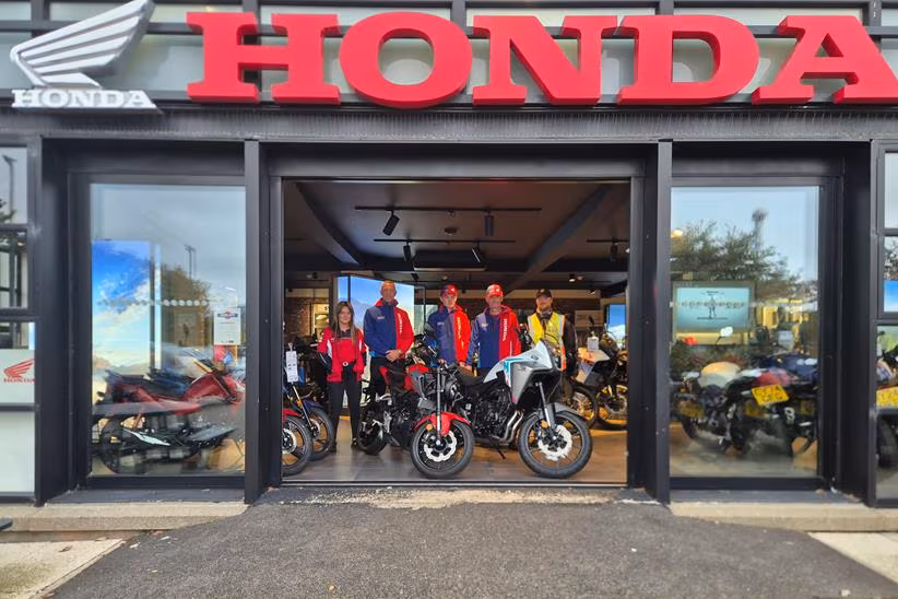 Oli and Joe Purkis stood at the Shirlaws Motorcycles dealership entrance