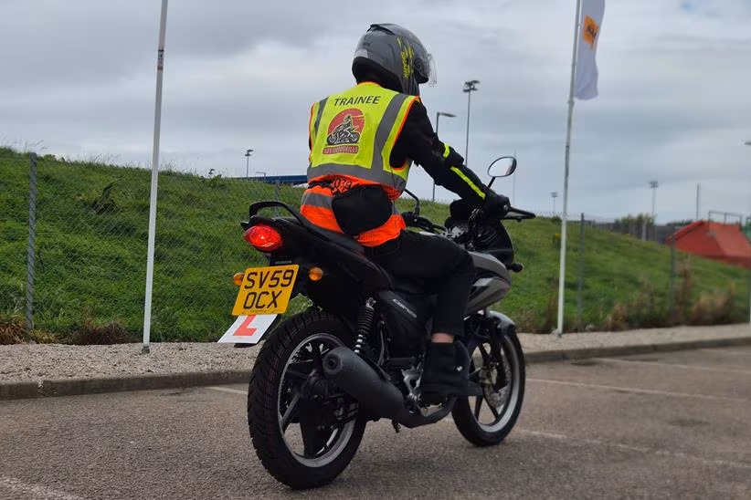 A rear shot of Oli Purkis training aboard a Honda CBF125