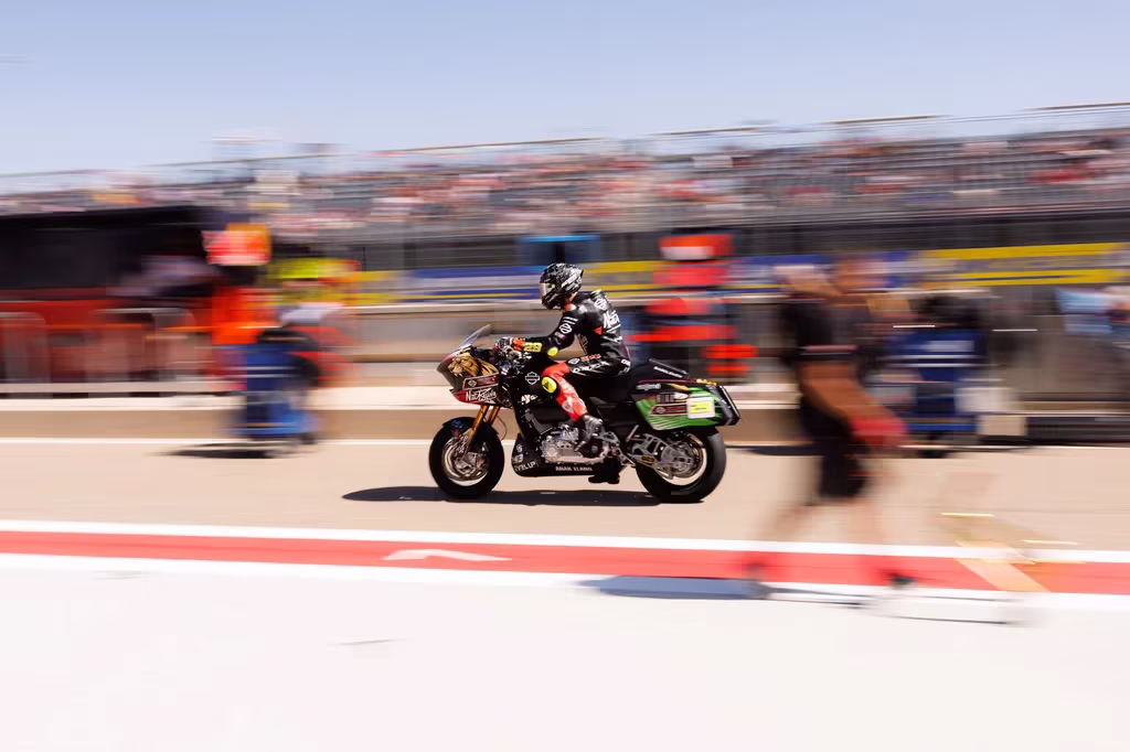 Andrea Iannone riding through pit lane in Aragon.