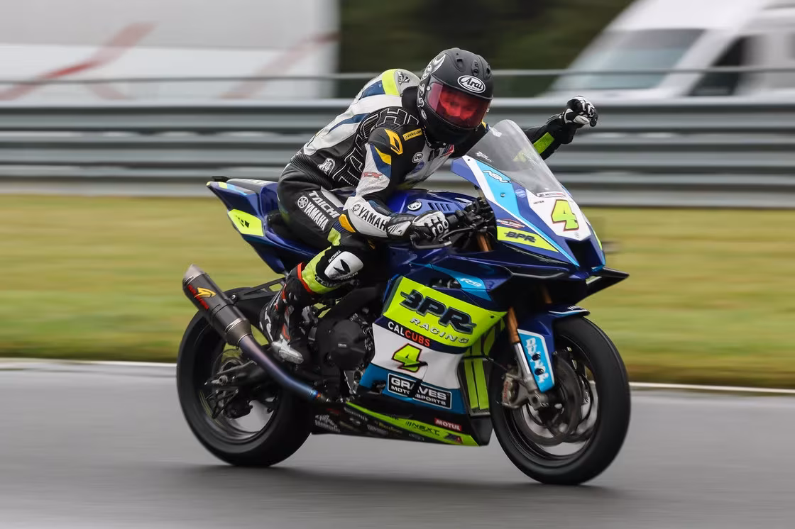 Hayes saluted his crew on pit wall as he crossed the line first in Supersport Race 1. Photo by Brian J. Nelson.