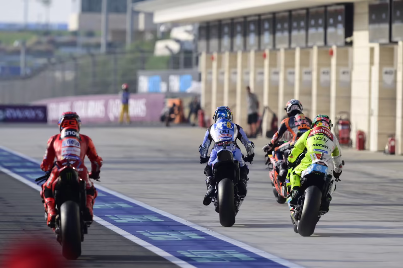 MotoGP bikes riding down pit lane in Qatar. Credit: Gold and Goose.